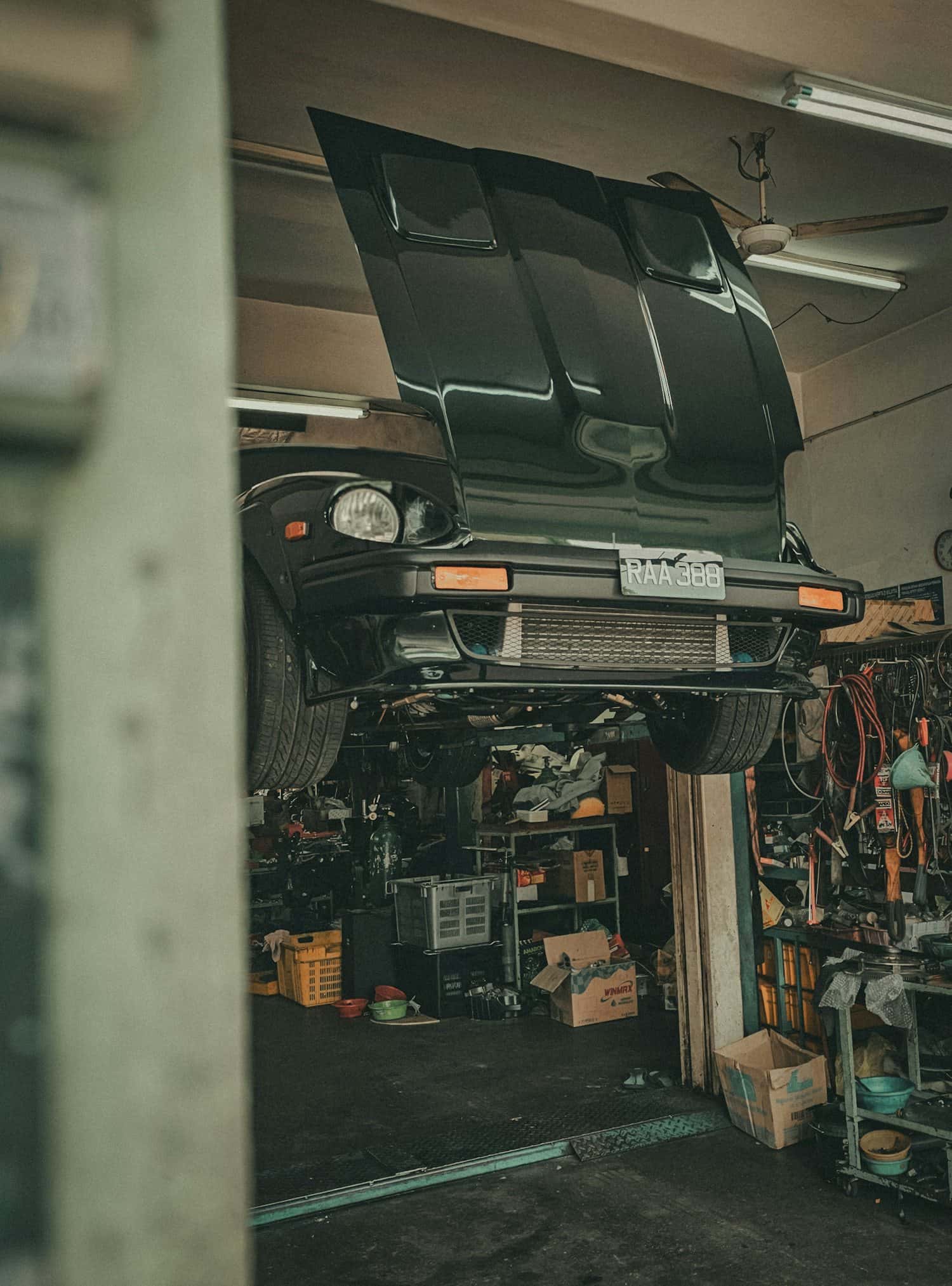 A car raised on a workshop ramp