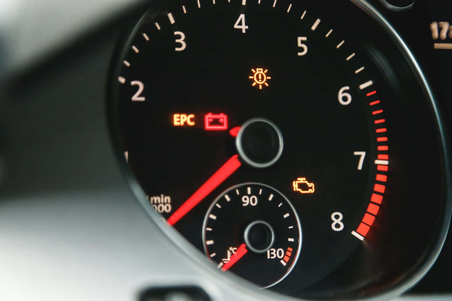 A car rev counter with the engine warning light, EPC and battery lamps lit