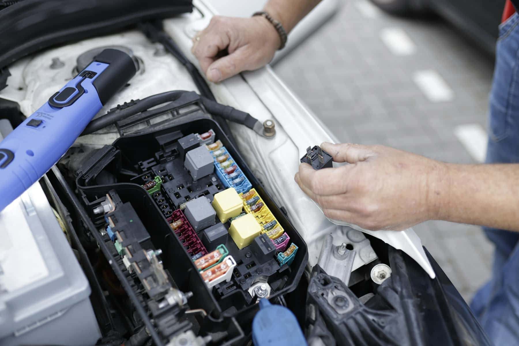Mechanic working in a car engine bay