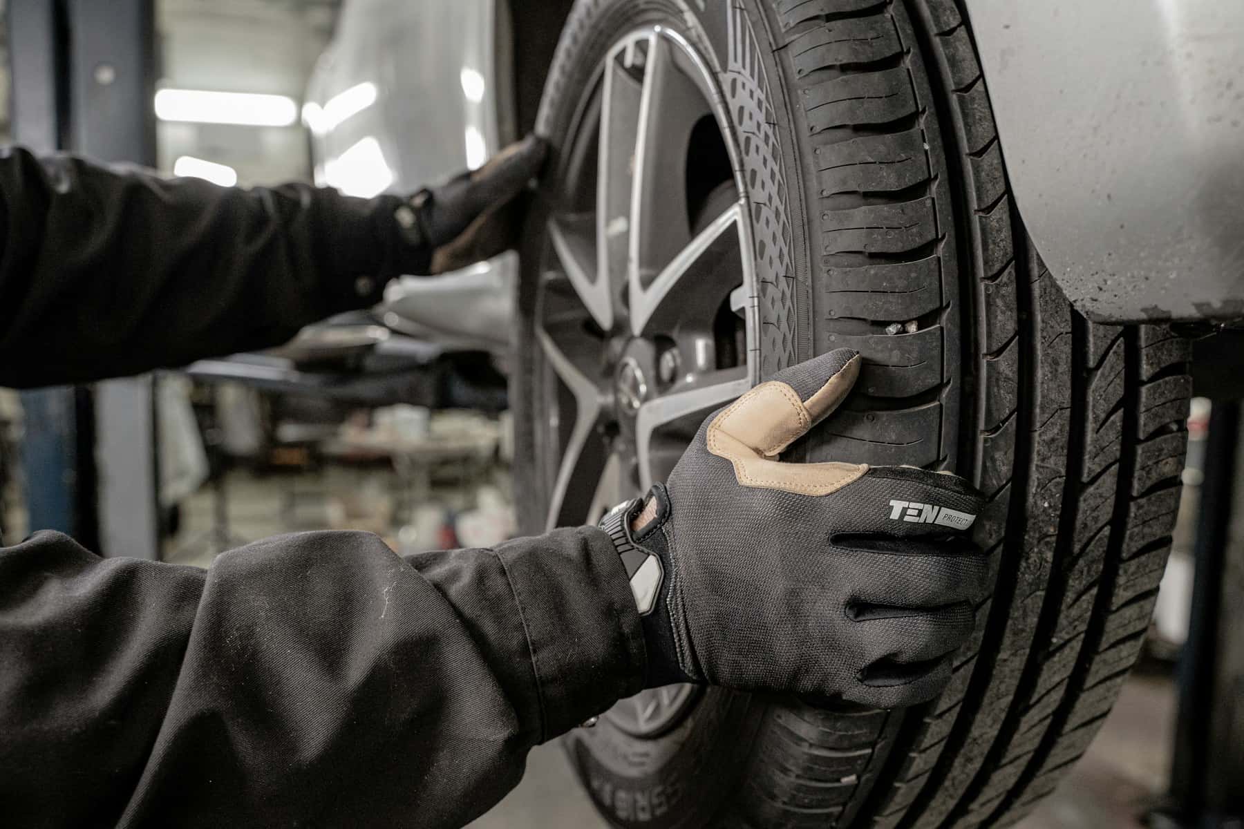 Mechanic working on a tyre in a garage