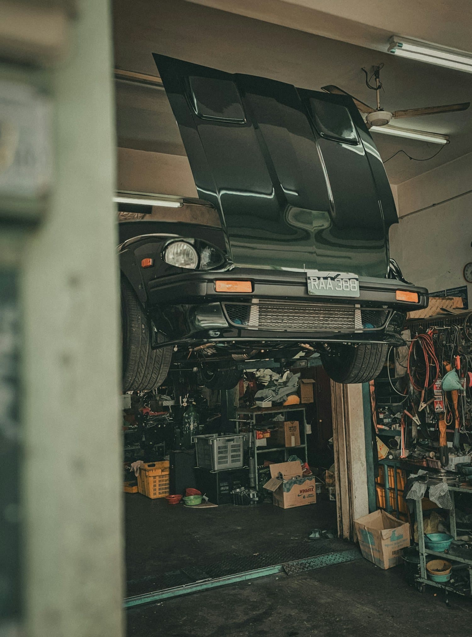 A car raised on a workshop ramp