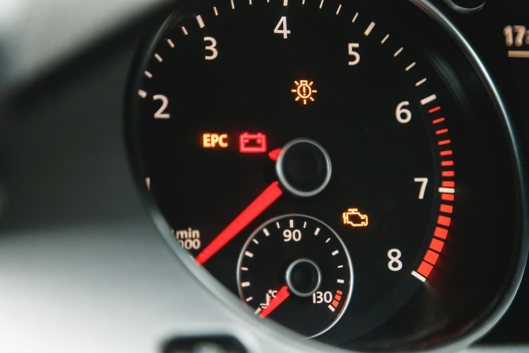 A car rev counter with the engine warning light, EPC and battery lamps lit