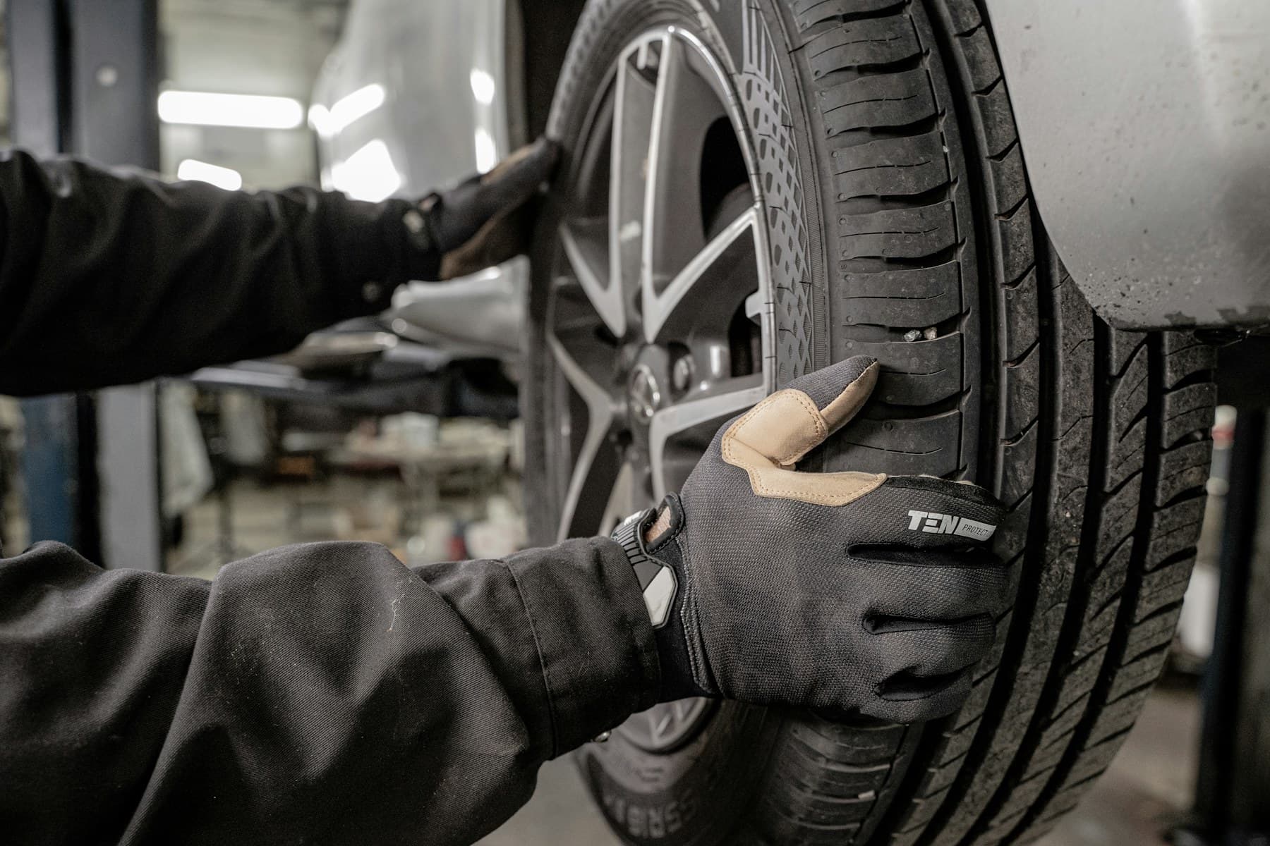 Mechanic working on a tyre in a garage