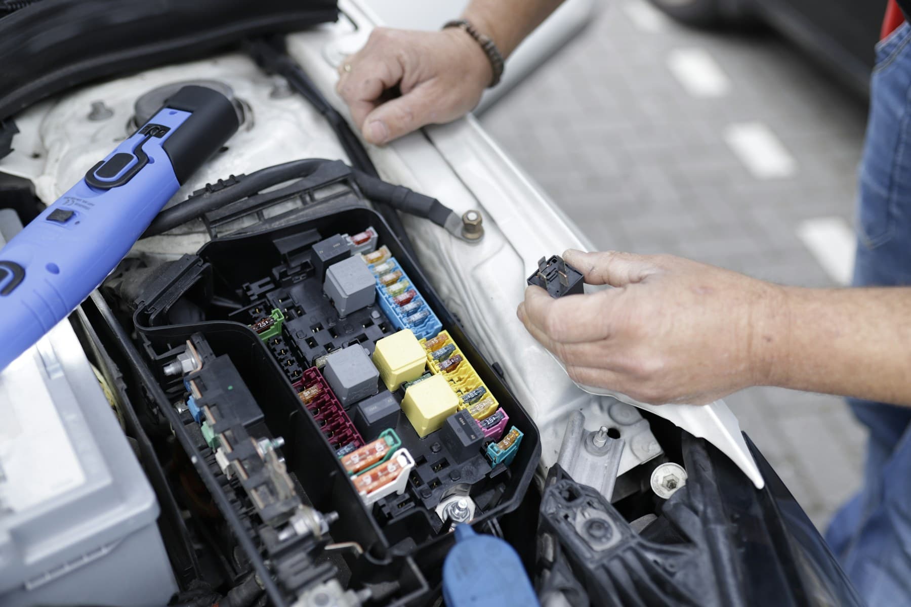 Mechanic working in a car engine bay